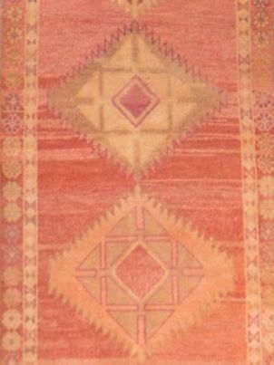 A red rug with a geometric pattern on it