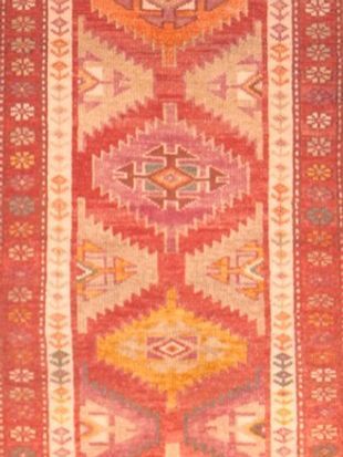 A red rug with a geometric pattern on it