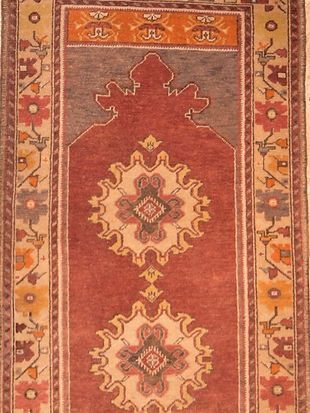 A red rug with a floral pattern on it