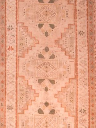 A close up of a rug with a pattern on it.
