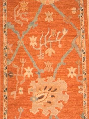 A close up of a rug with flowers on it