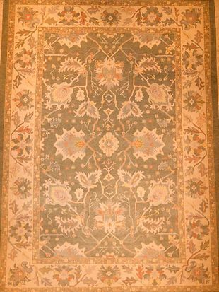 A rug with a floral pattern on it is sitting on a table.