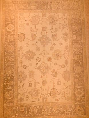 A rug with a floral pattern on it is sitting on a table.
