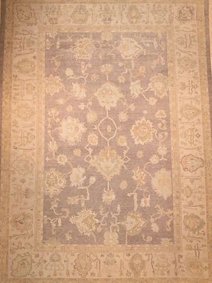 A rug with a floral pattern on it is sitting on a table.