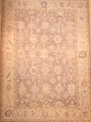 A rug with a floral pattern on it is sitting on a wooden table.