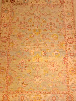 A close up of a rug with a floral pattern on it.