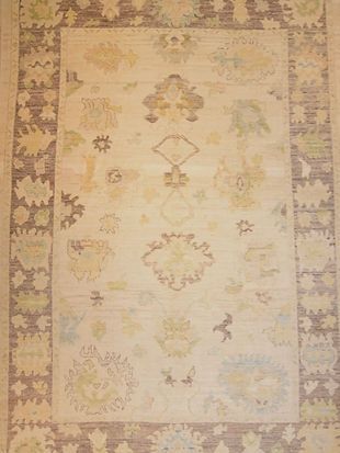 A rug with a floral pattern on it is sitting on a table.