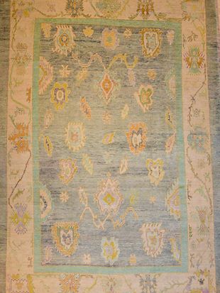 A rug with a floral pattern on it is sitting on a table.
