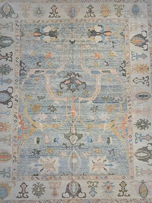 A close up of a rug with a floral pattern on it.