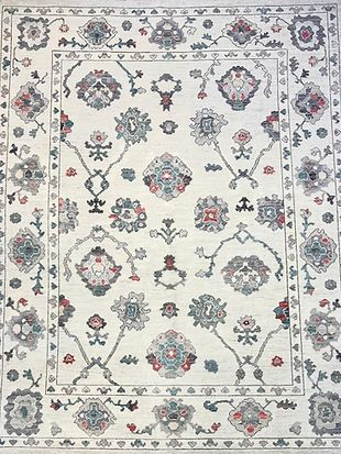 A white rug with a floral pattern on it