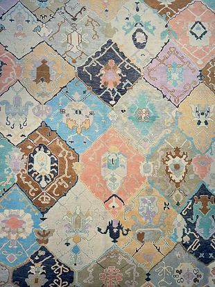 A close up of a rug with a colorful pattern on it.