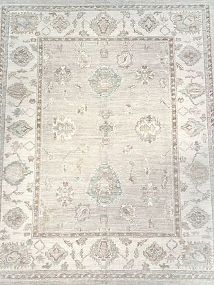 A close up of a rug with a floral pattern on it.