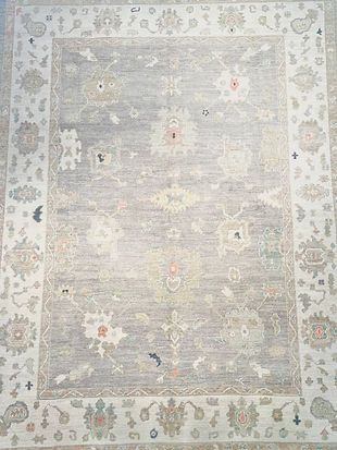 A large rug with a floral pattern on it is sitting on a table.