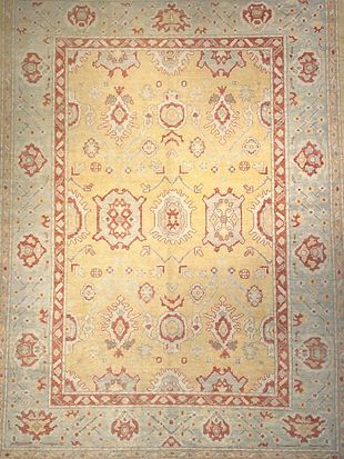 A rug with a floral pattern on it is sitting on a table.