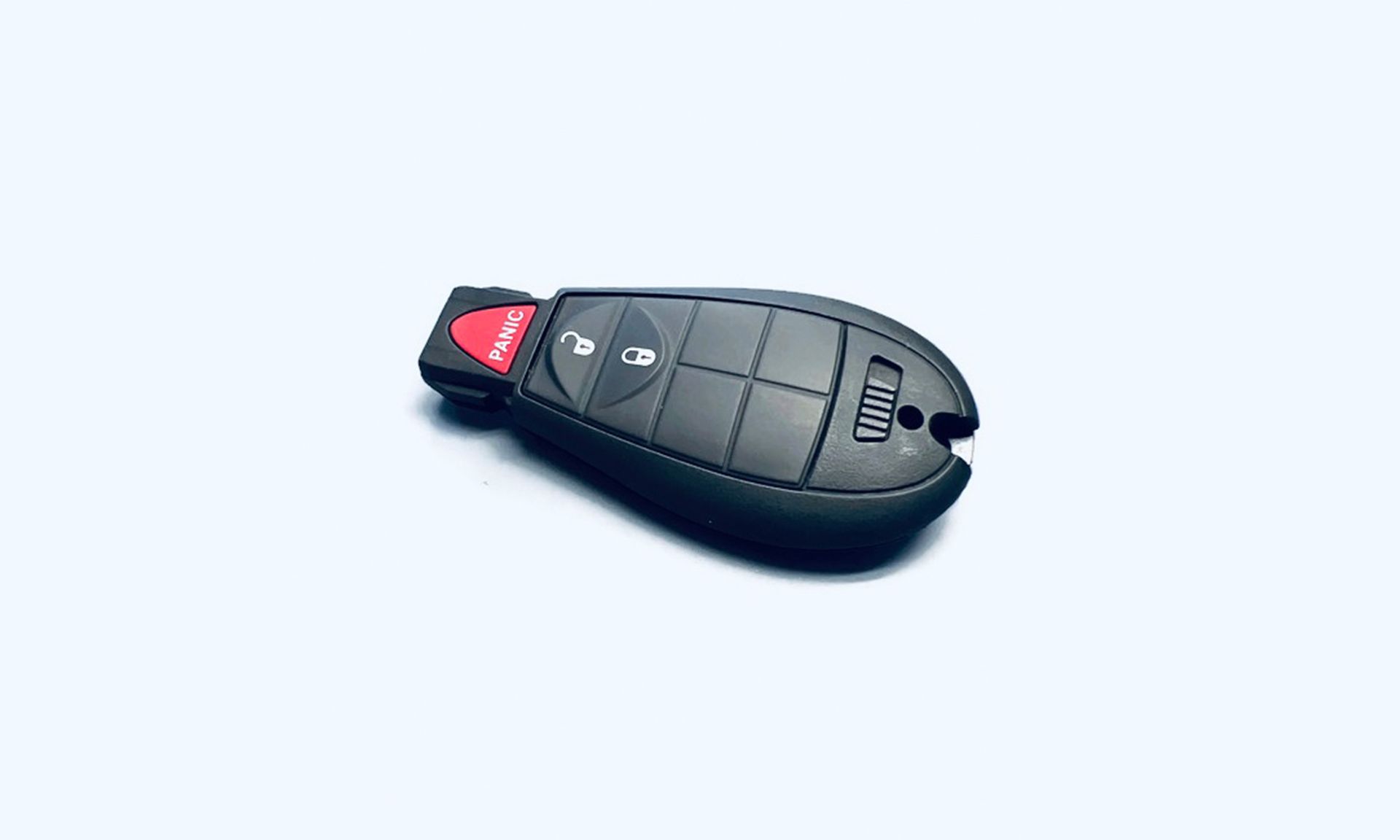Black car key fob with red panic button, on white background.