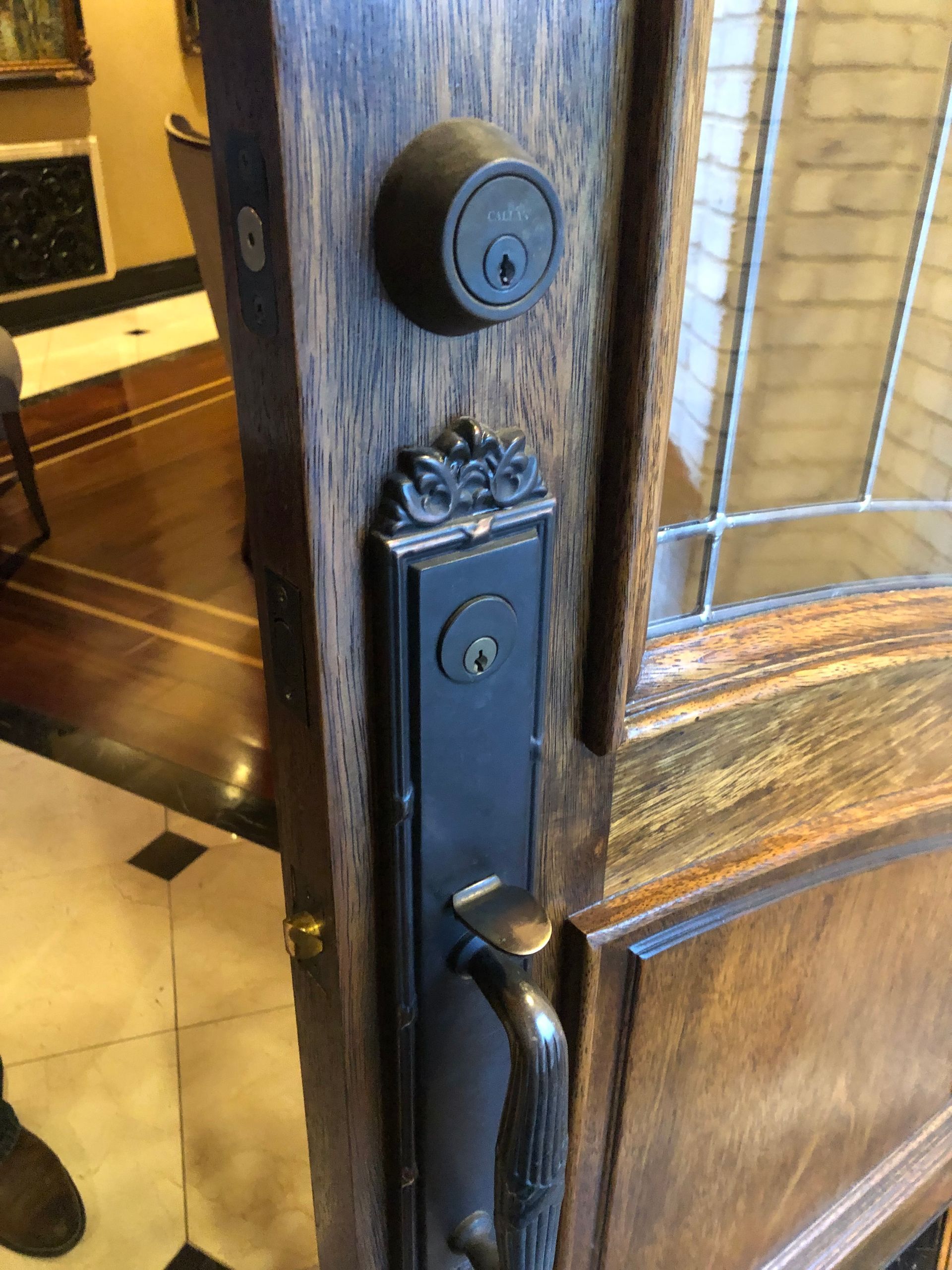 Door with a dark brown handle and deadbolt. A keyhole is visible. The door is wooden.