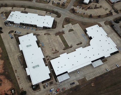 white roofing of 3 commercial buildings