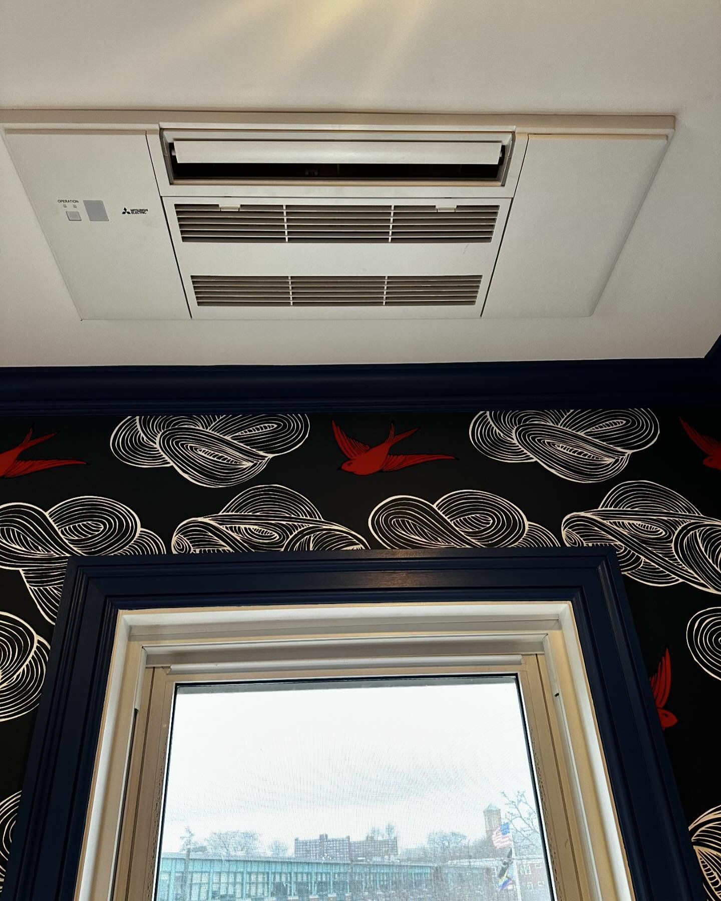 a window with a ceiling mounted air conditioner above it