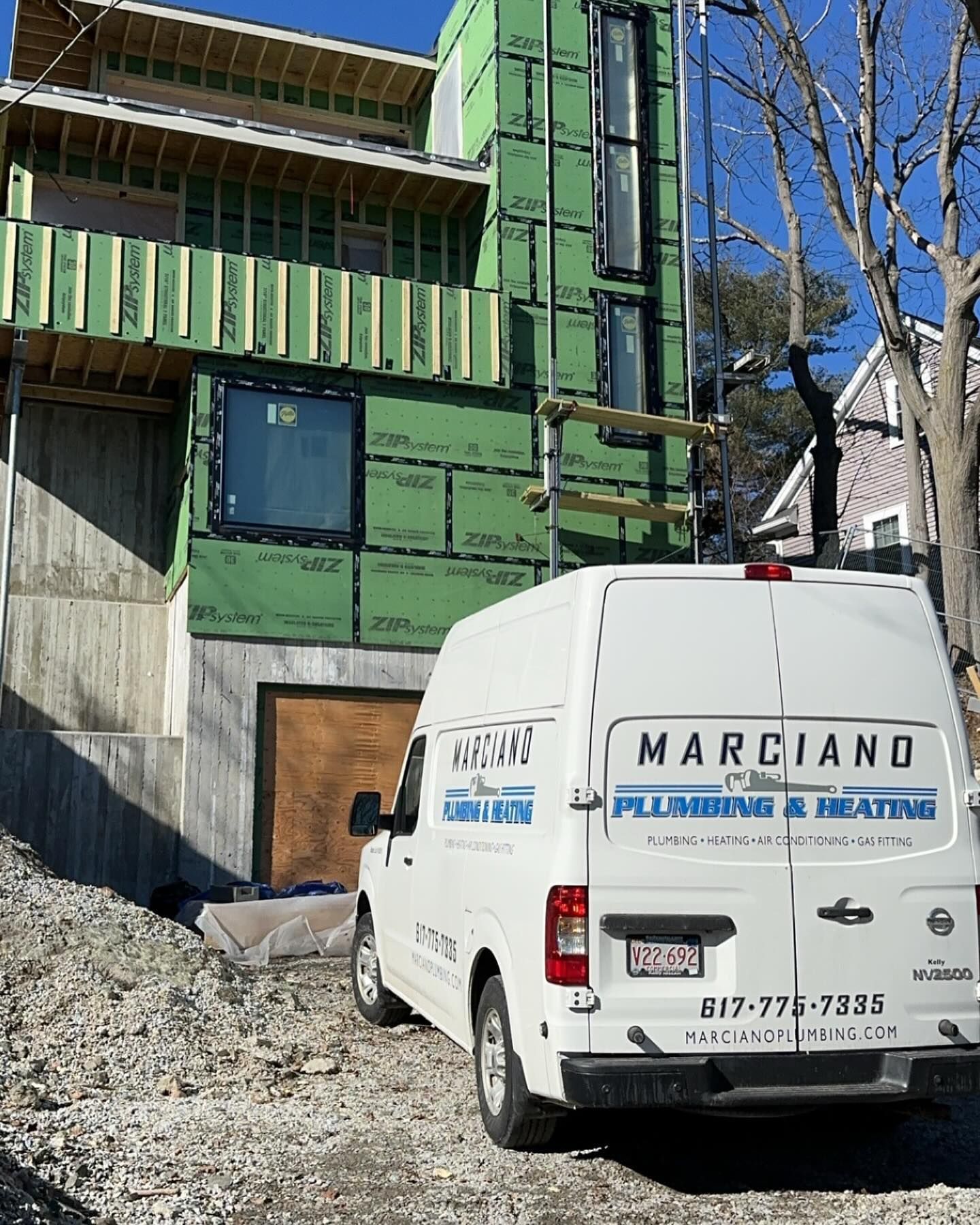 a white van is parked in front of a building under construction