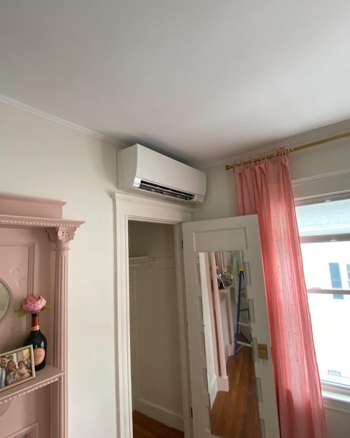 a room with a mirror and a ceiling fan