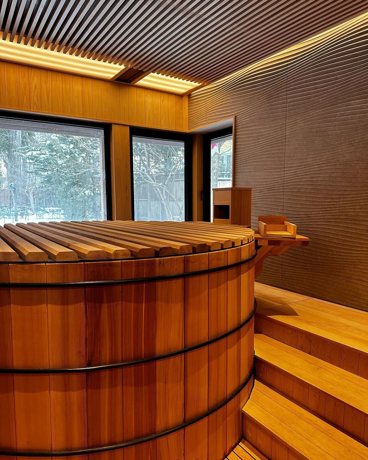 there is a large wooden tub in the middle of the room