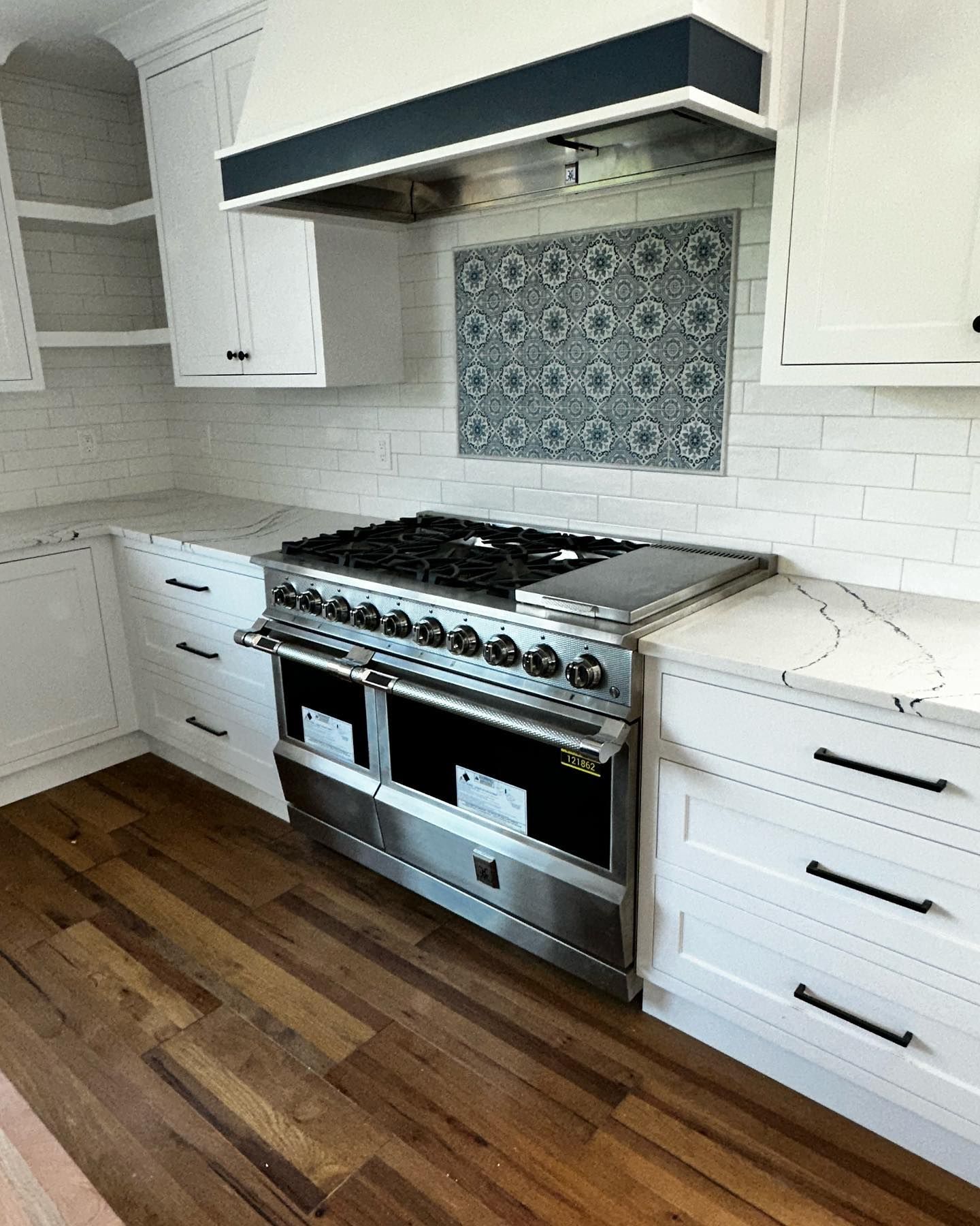 a kitchen with stainless steel appliances and white cabinets
