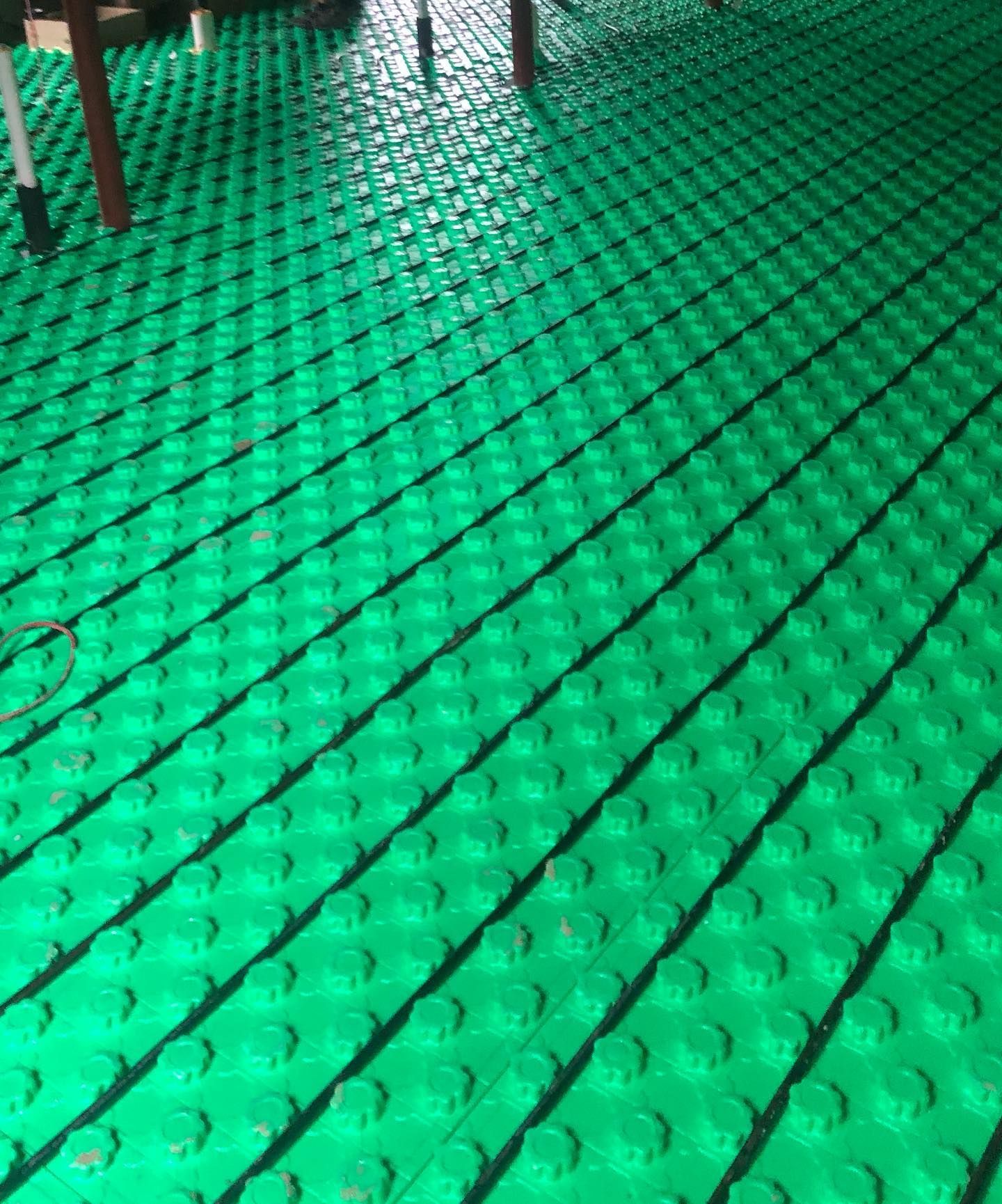 a close up of a green floor with a grid pattern