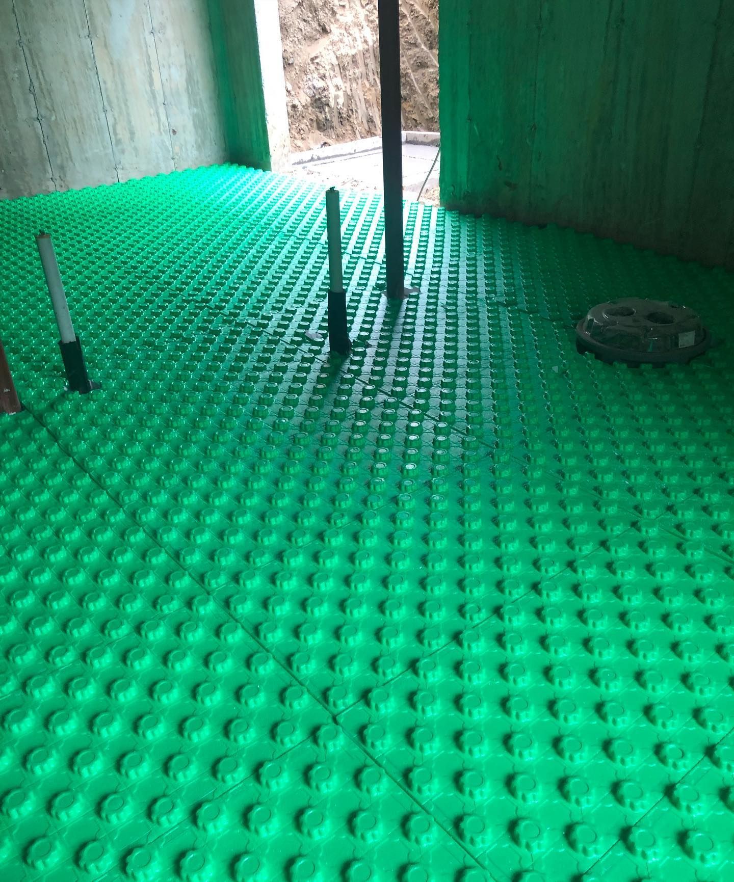 a green floor with a lot of holes in it