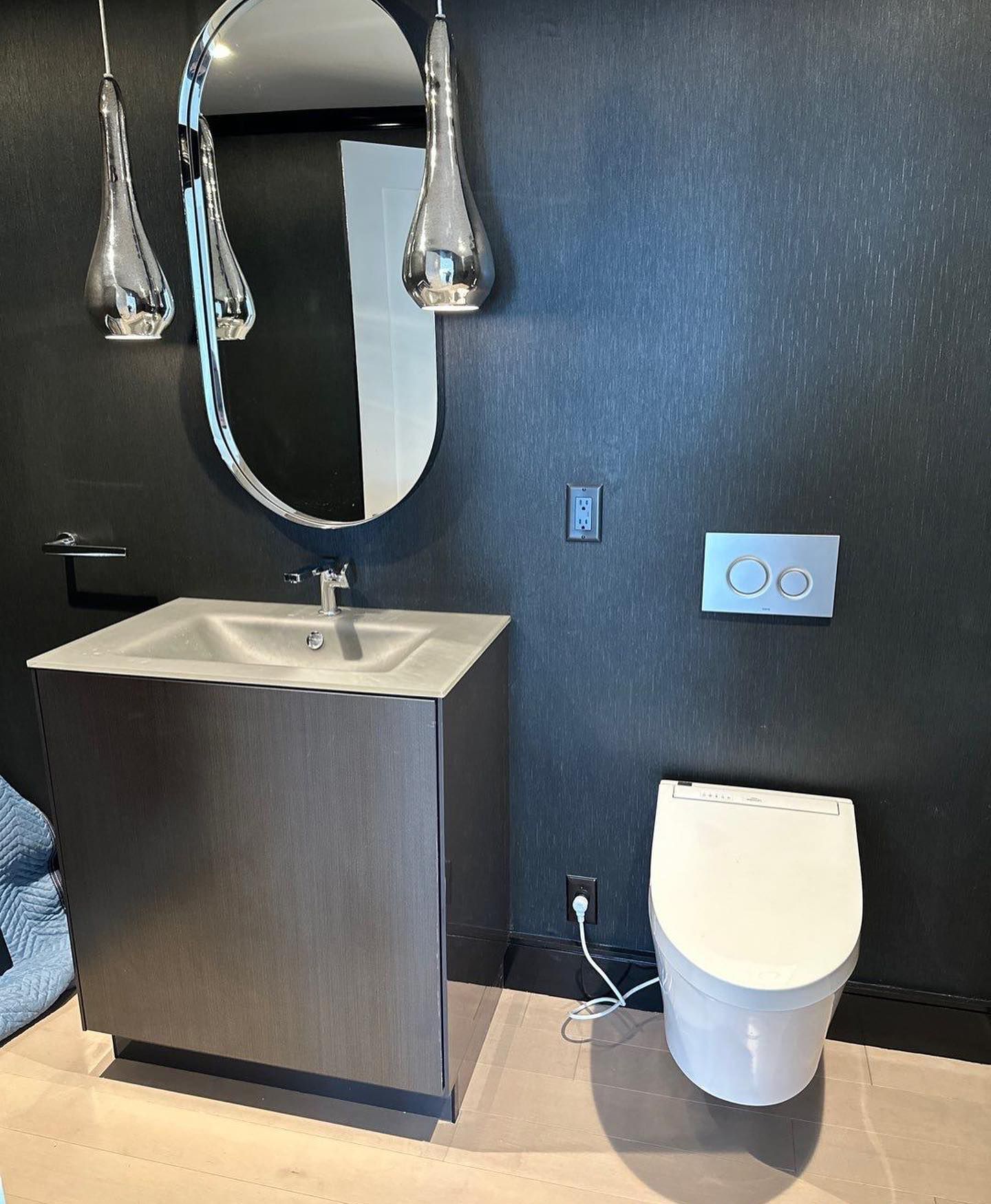 a bathroom with a toilet a sink and a mirror