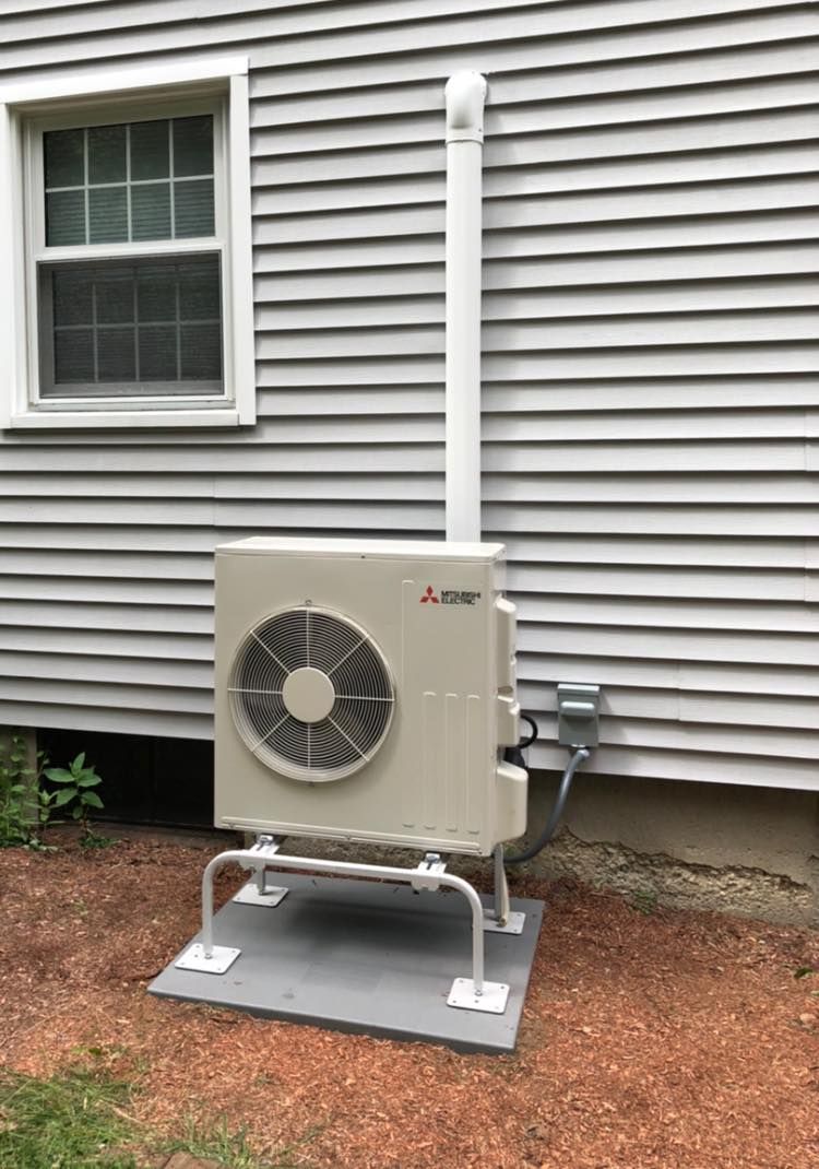 a Mitsubishi air conditioner is installed on the side of a house