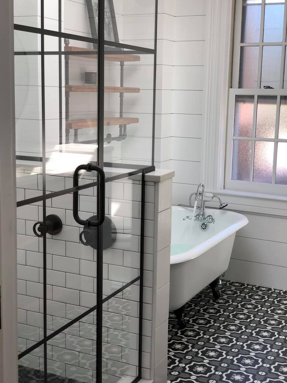 a bathroom with a bathtub and a walk in shower