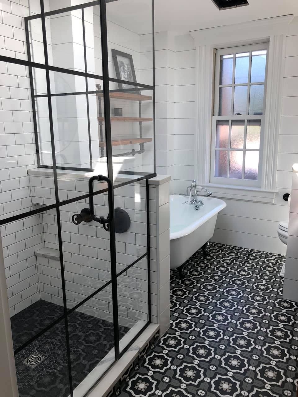 a bathroom with a bathtub and a walk in shower