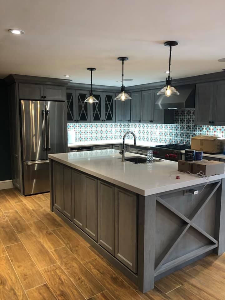 a kitchen with a large island and stainless steel appliances