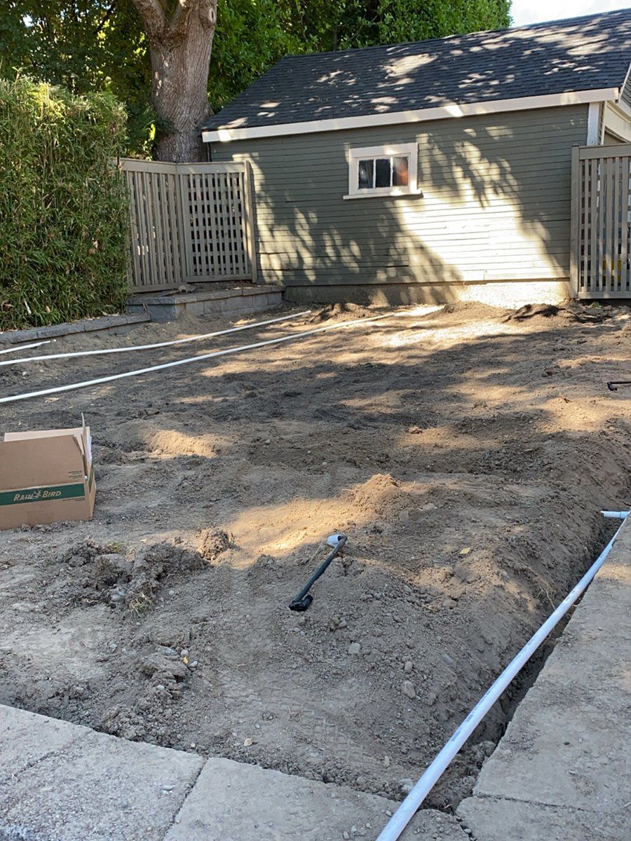 There is a lot of dirt in the backyard of a house.
