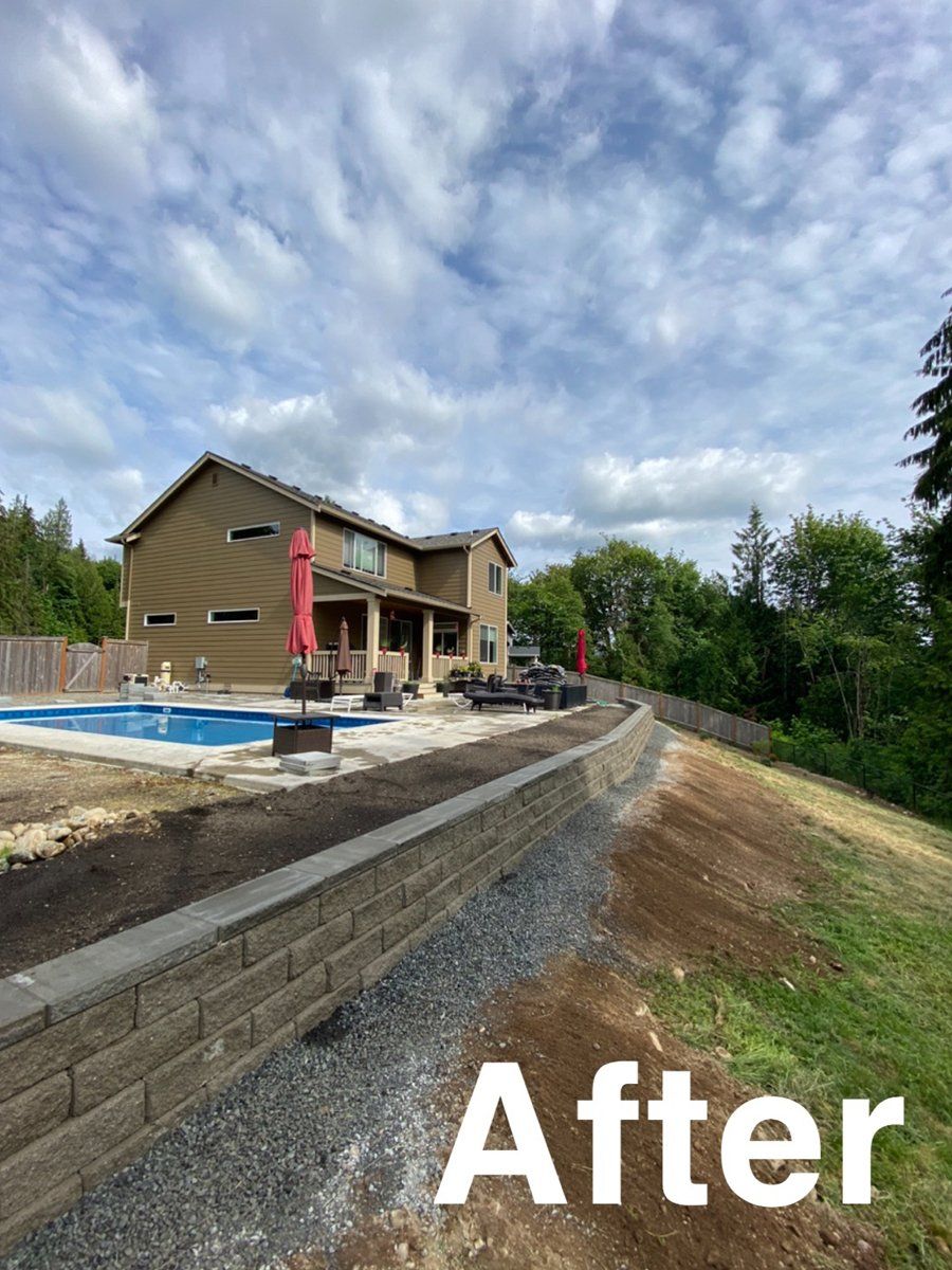 A picture of a house with a pool and a brick wall.