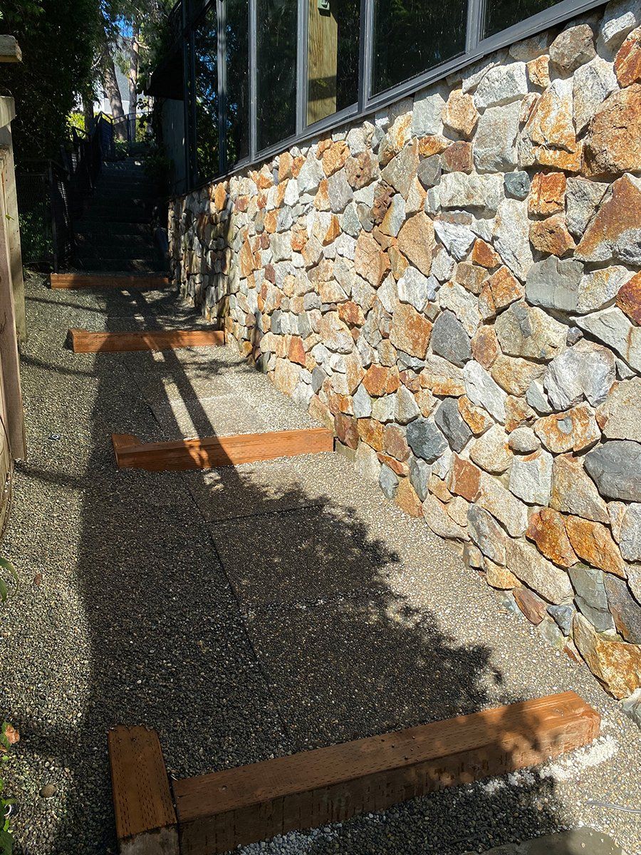 A stone wall with wooden steps leading up to it.