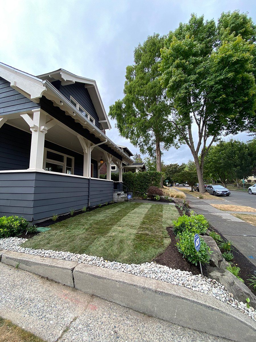 A house with a lush green lawn in front of it.