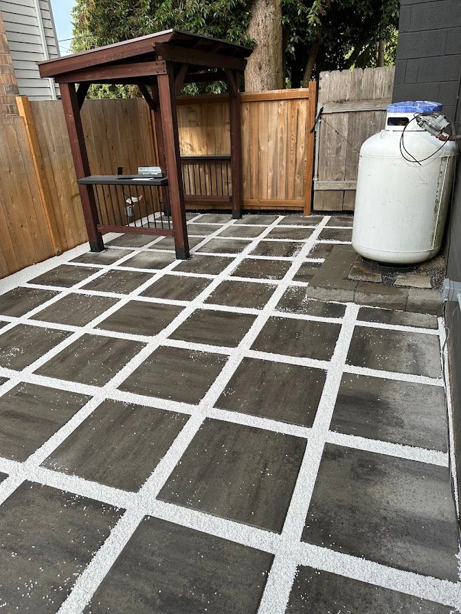 A patio with a gazebo and a propane tank.