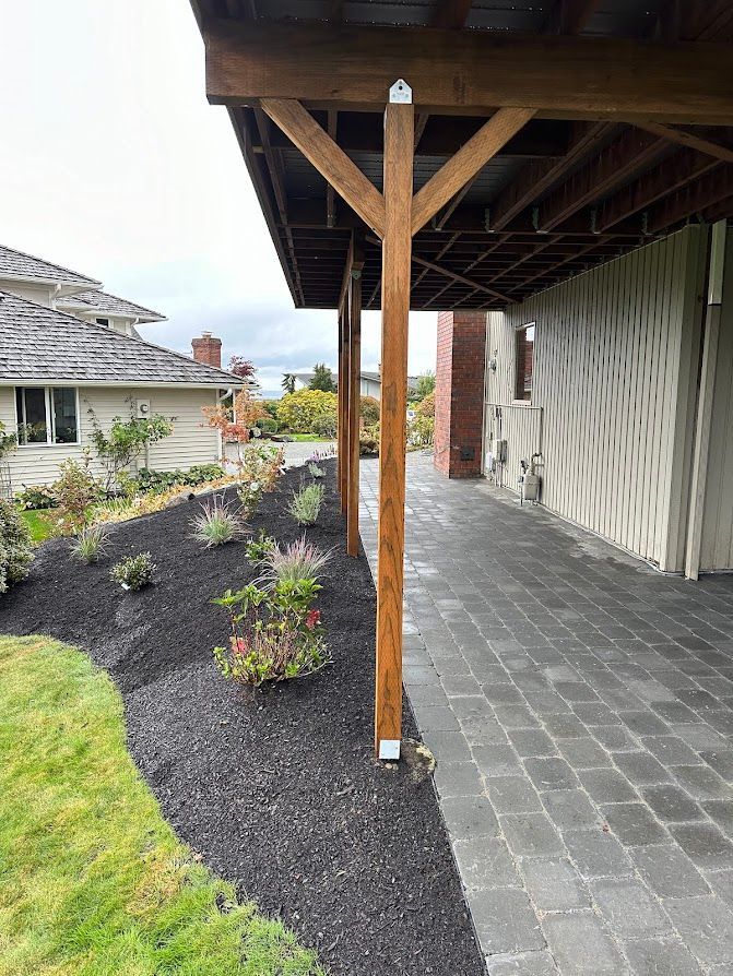 There is a covered walkway leading to a house.