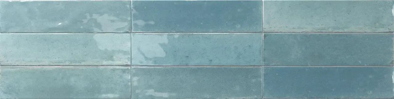 Blue-green painted wall with horizontal tile-like panels and subtle texture