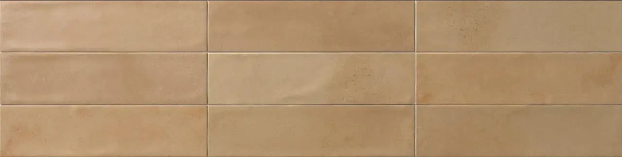 Tan tiled wall with a subtle grid pattern in beige and tan shades