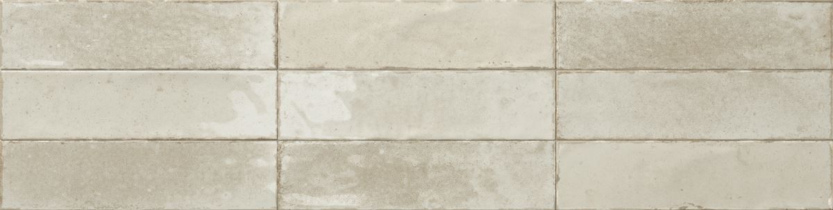 Close-up of light beige stone tile wall with horizontal and vertical grout lines