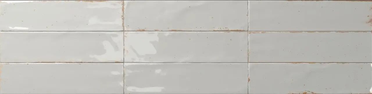 Gray tiled wall with a vertical seam and faint stains