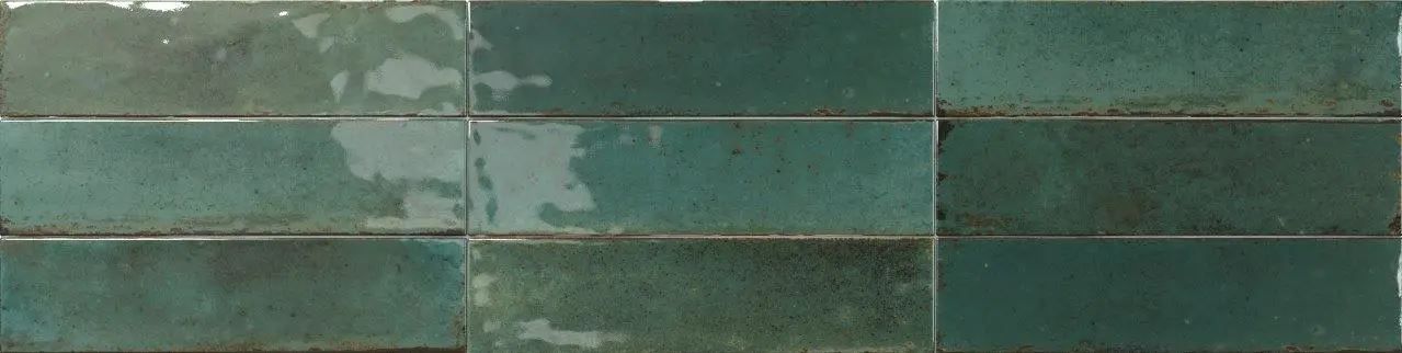Green tiled wall with horizontal bands and worn, weathered texture
