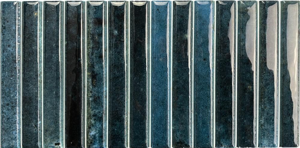 Vertical blue-gray corrugated metal panels with worn, weathered white streaks