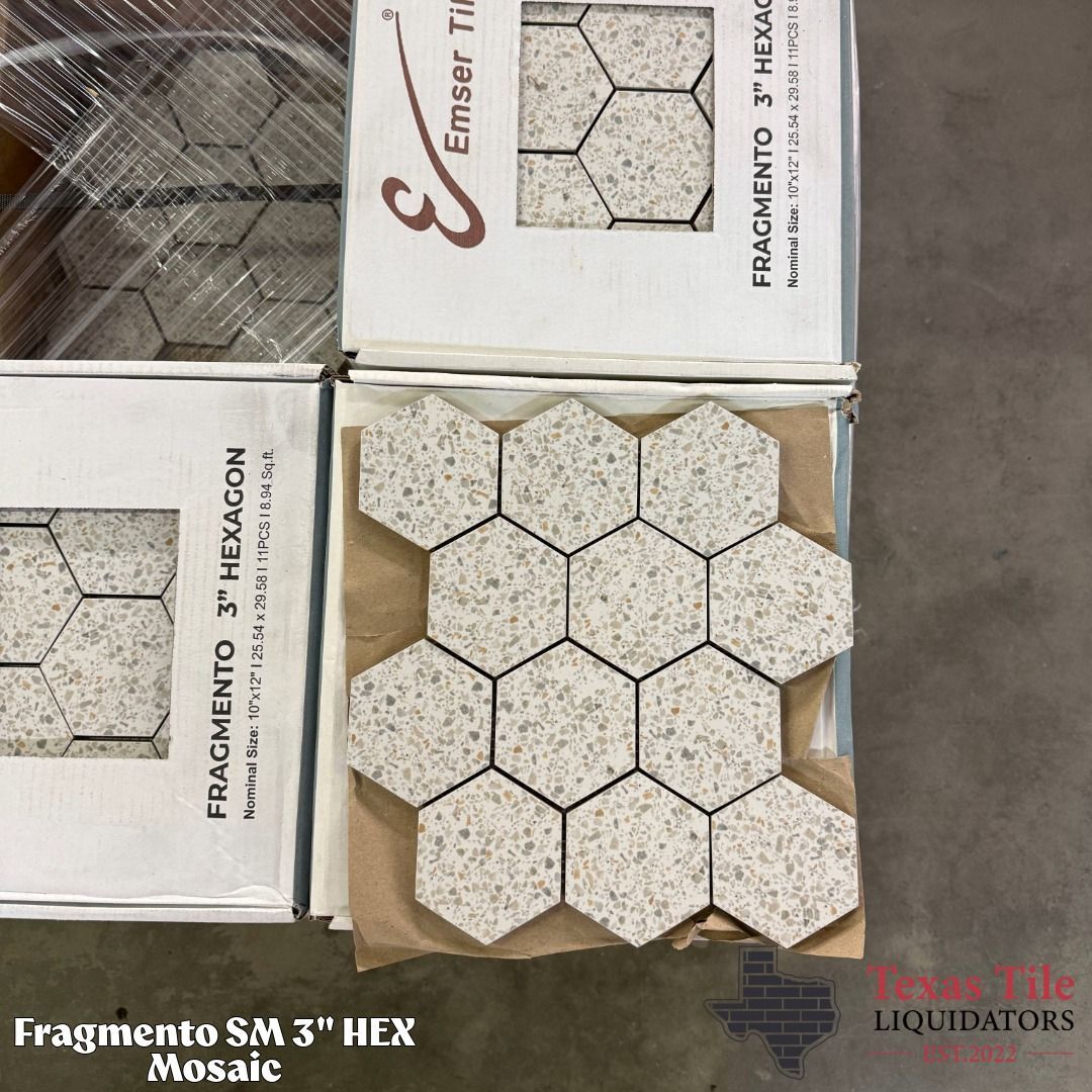 Hexagonal beige-speckled tile samples in open packaging with printed labels.