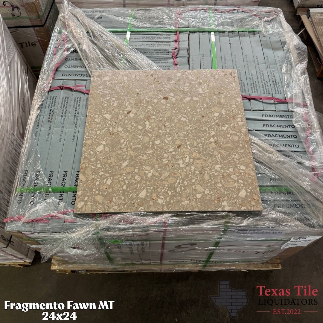 Square beige speckled tile on a pallet wrapped in plastic, with “Fragmento Fawn MT 24x24” visible.