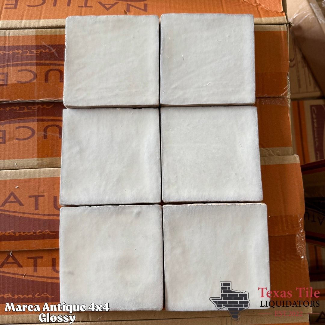Six white square pads arranged in a 2x3 grid on a cardboard surface