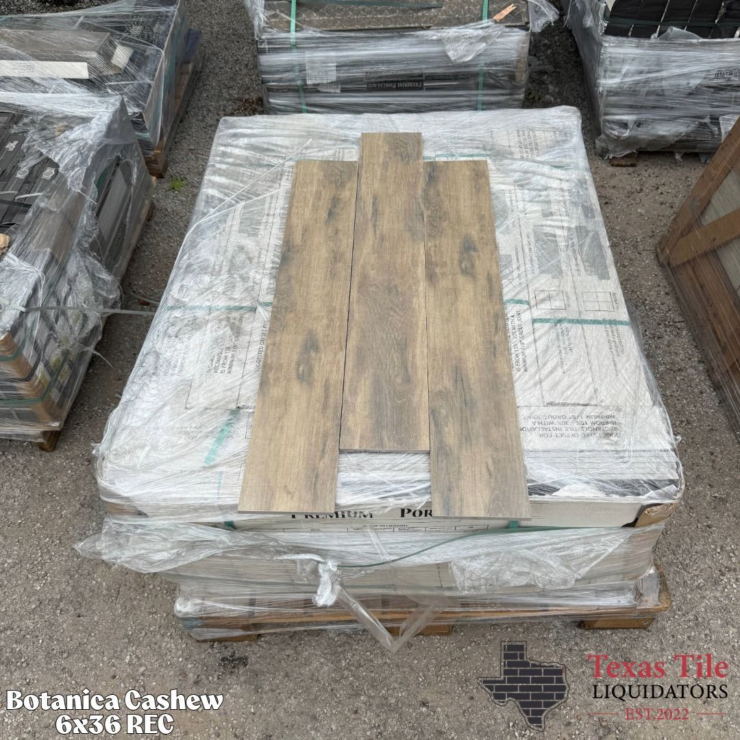 Pallet of wrapped stone or tile slabs with wood planks on top in a warehouse yard