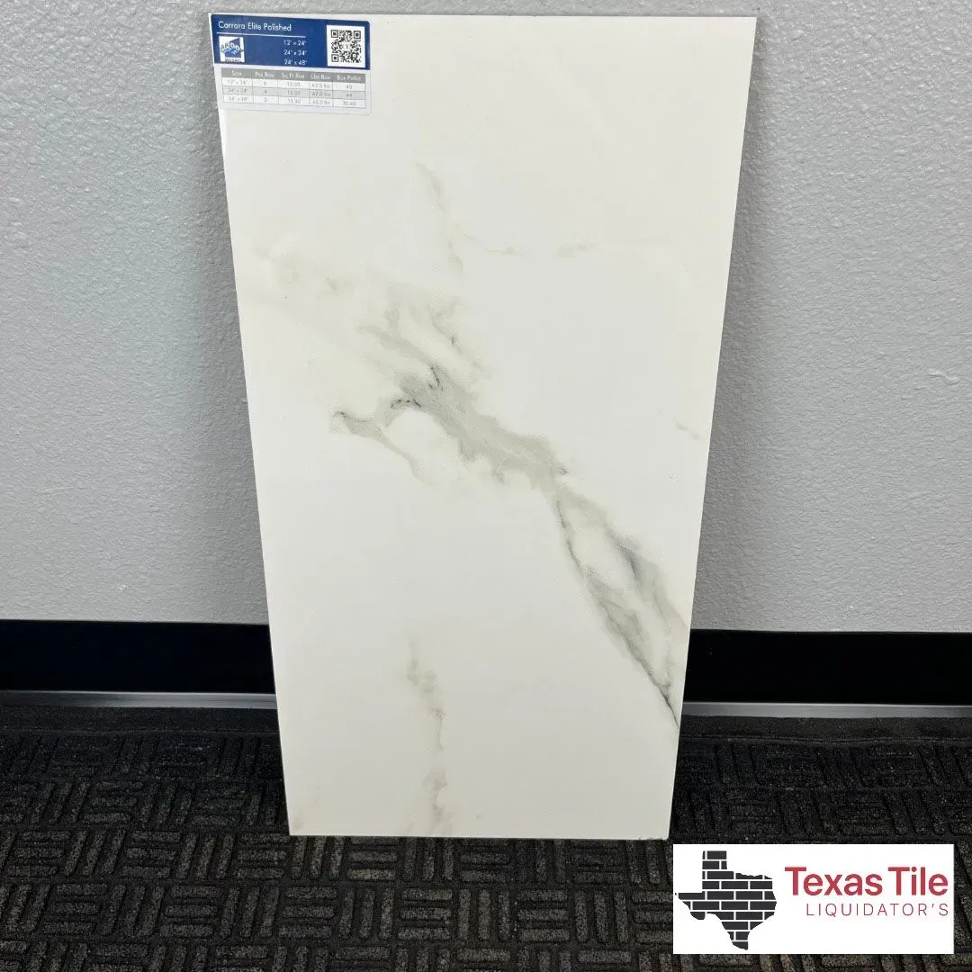 A white porcelain tile with grey marble veining standing on a grey carpeted floor with a company logo in the corner.